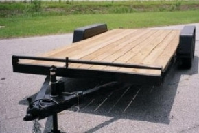 Image of car trailers. One with runners, one with a wood deck and one with a metal deck.